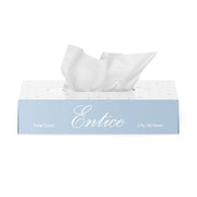 Box of Entice facial tissues with white tissue paper on a white background